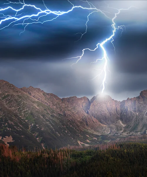 A mountain peak being struck by lightning