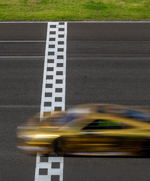 A car blurring across the finish line