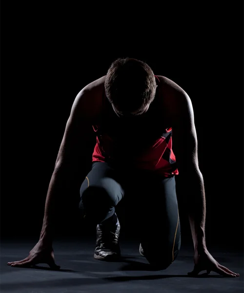 A runner prepping for his start